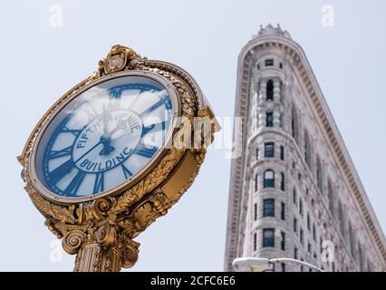 Von unten exquisite Uhr mit Fifth Avenue Building Inschrift In der Nähe des Flatiron Gebäudes im Zentrum von New York Stockfoto