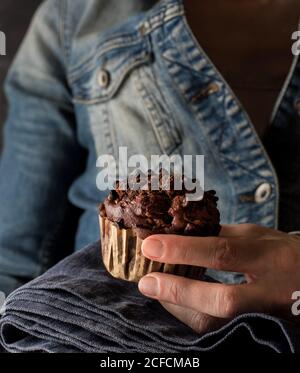 Nicht erkennbare Frau hält köstliche Schokolade Banane Muffin in der Hand in der Nähe Kamera Stockfoto