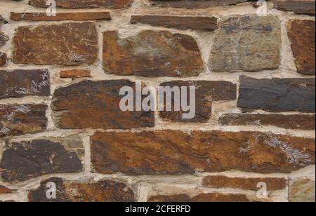 Hintergrund oder Textur einer Granitsteinwand aus einem traditionellen Devon Landhaus in Rural Devon, England, UK Stockfoto
