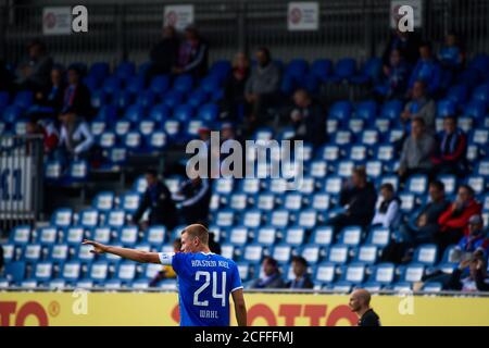 05. September 2020, Schleswig-Holstein, Kiel: Fußball: Testspiele, KSV Holstein - FC Hansa Rostock. Kiels Hauke Finn Wahl gibt seinen Teamkollegen vor den spärlich besetzten Zuschauertribünen Anweisungen. Zum ersten Mal seit der Corona-Pandemie werden 500 Zuschauer zum Spiel zugelassen. Foto: Gregor Fischer/dpa - WICHTIGER HINWEIS: Gemäß den Vorschriften der DFL Deutsche Fußball Liga und des DFB Deutscher Fußball-Bund ist es verboten, im Stadion und/oder aus dem Spiel aufgenommenen Fotografien in Form von Sequenzbildern und/oder videoähnl. Phot zu nutzen oder auszunutzen Stockfoto