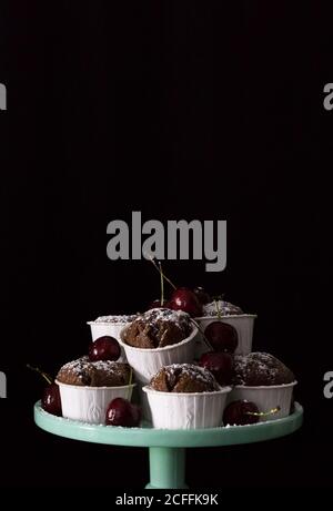 Teller mit Cupcakes und Kirschen Stockfoto
