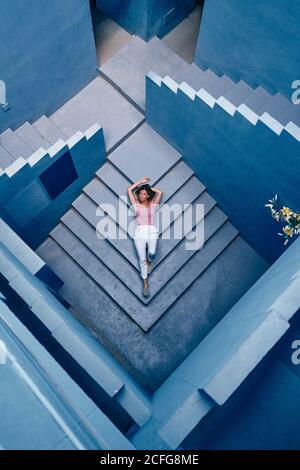 Draufsicht auf die Frau, die auf dem blauen Gebäude liegt Stockfoto