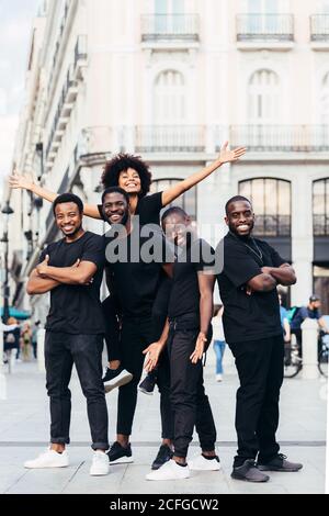 Glückliche schwarze Rennfreunde hängen in der Stadt an einem Sommertag. Stockfoto