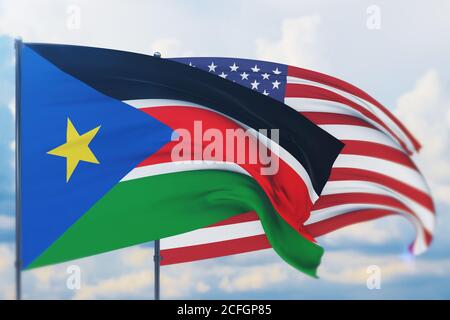 Schwenkende amerikanische Flagge und Flagge des Südsudan. Nahaufnahme, 3D-Illustration. Stockfoto