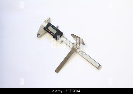 Sehr alte gebrauchte rostige Eisensätteln und digitale elektronische Vernier Bremssättel auf weißem Hintergrund isoliert Stockfoto
