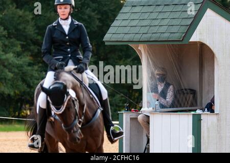 Raeford, North Carolina, USA. September 2020. 5. September 2020 - Raeford, North Carolina, USA - Richterin Sue Smithson beobachtet NOBIE KANONEN reiten Bust A Groove konkurrieren in der Dressur bei den Five Points Horse Trials, 5. September 2020 im Carolina Horse Park in Raeford, N.C. Die Pferdeprüfung besteht aus drei verschiedenen Prüfungen - Dressur, Cross-Country und Springreiten, die in der Regel an einem oder zwei Tagen. Die Teilnehmer müssen während jeder Veranstaltung das gleiche Pferd reiten. Die Five Points Horse Trials ziehen Reiter und ihre Pferde aus dem Osten der Vereinigten Staaten an. (Bild: © Timothy L. H. Stockfoto