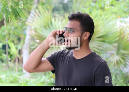 Überrascht junger asiatischer Mann im Gespräch auf Handy, Jugend schaut erstaunt Stockfoto