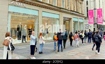 Glasgow, Schottland, UK, 6. September, 2020: UK Wetter: Sonniges Sommerwetter und wahrscheinlich das letzte des Jahres sahen Einheimische und Touristen genießen die Grüns des George Square und die Straßen des Stadtzentrums, während die Stadt in Lockdown weiter als die Massen waren auf buchanan Straße auf der Stil Meile Schlange für den Eingang zu zara Während Sperrregeln... Quelle: Gerard Ferry/Alamy Live News Stockfoto