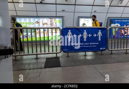 Ein soziales Distanzierungsbanner auf dem Geländer in der Holborn London Underground, das den Passagieren aufzeigt, zwei Meter voneinander entfernt zu bleiben. Stockfoto