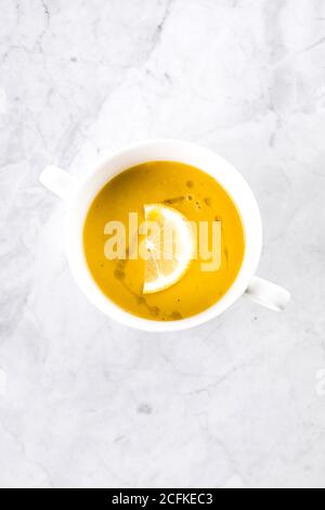 Linsensuppe in der weißen Schale auf Marmortisch. Draufsicht. Stockfoto