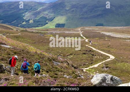 Menschen, die den Hauptweg von Loch Brandy nach Glen Clova, Angus, Schottland, hinunterfahren Stockfoto