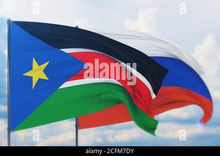 Winkende russische Flagge und Flagge des Südsudan. Nahaufnahme, 3D-Illustration. Stockfoto