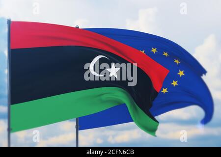 Flagge der Europäischen Union und Flagge Libyens schwenken. Nahaufnahme, 3D-Illustration. Stockfoto