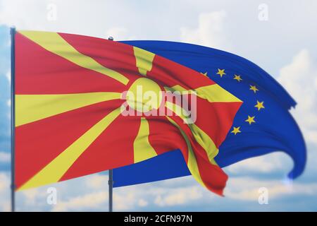 Flagge der Europäischen Union und Flagge Nordmazedoniens schwenken. Nahaufnahme, 3D-Illustration. Stockfoto