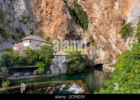 Derwisch-Haus an der Buna-Quelle mit einer Höhle in der Nähe an einem sonnigen Sommertag in Blagaj, BiH Stockfoto