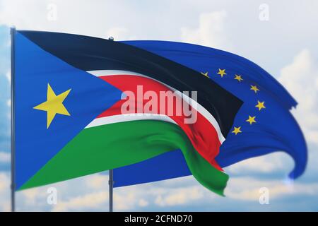 Flagge der Europäischen Union und Flagge des Südsudans schwenken. Nahaufnahme, 3D-Illustration. Stockfoto