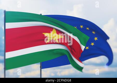 Flagge der Europäischen Union und Flagge von Suriname schwenken. Nahaufnahme, 3D-Illustration. Stockfoto