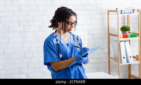 Portrait von afroamerikanischen Tierarzt Schreiben auf Zwischenablage bei Tierklinik Stockfoto