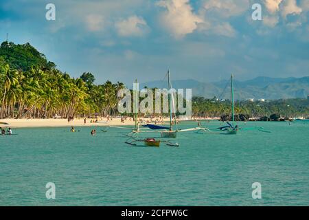 Boracay, Philippinen - 29. Januar 2020: Weißer Strand der Insel Boracay. Touristen gehen am Strand entlang und schwimmen im Meer. Einige Tage vor dem Ausbruch Stockfoto