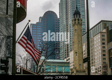 CHICAGO, VEREINIGTE STAATEN - 21. Feb 2010: Chicago, Illinois, USA - 21. Februar 2010: ensign der Vereinigten Staaten vor einem alten Turm und Wolkenkratzer Stockfoto