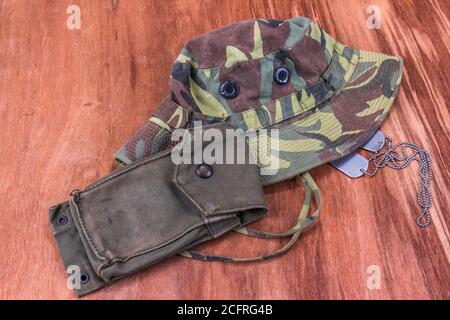 Vietnam Era Jungle Green Hut, Dog Tags & Ammo Pouch Auf Holzhintergrund Stockfoto