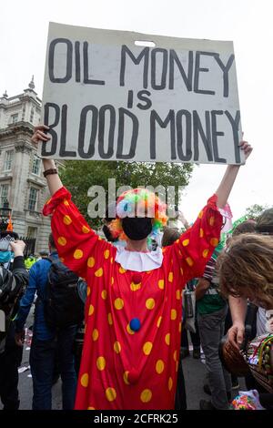 Protestler in Clown Kostüm mit Plakat, 'Karneval der Korruption' Extinction Rebellion Demonstration, London, 3. September 2020 Stockfoto