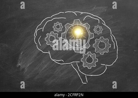 Rotierende Zahnräder im menschlichen Gehirn. Illustration auf Tafel.Konzept der Idee. Stockfoto