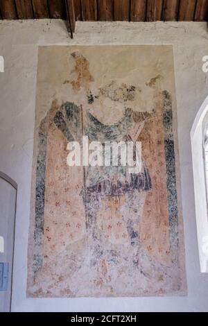 Frühes 14. Jahrhundert Gemälde von St. Christopher im Kirchenschiff der Allerheiligen Kirche, fring in Norfolk. Stockfoto