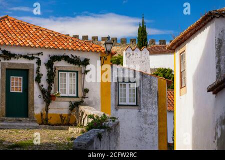 Historische ummauerte Stadt Obidos, in der Nähe von Lissabon, Portugal. Schöne Straßen von Obidos mittelalterliche Stadt, Portugal. Blick auf die Straße der mittelalterlichen Festung in Obidos Stockfoto