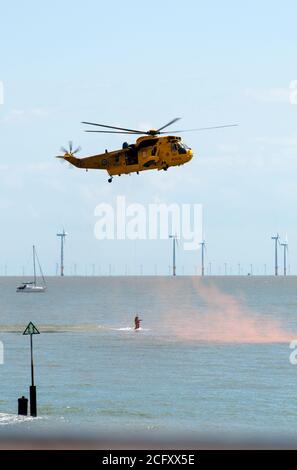 Rettungshubschrauber in Aktion schwebt über dem Meer. Stockfoto