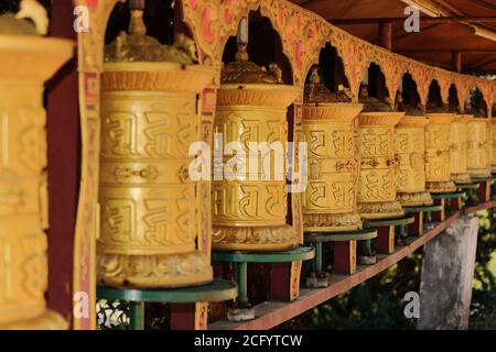 Buddhistisches Gebet Räder in einer Reihe in einem tibetischen Kloster In Sikkim Indien Stockfoto