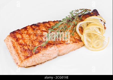 Gebratenes rotes Fischfilet, gekocht mit Gewürzen, isoliert auf Weiß Nahaufnahme im Hintergrund Stockfoto