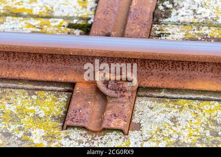 Rostige, korrodierte Schienen der Southend Pier Railway, in Southend on Sea, Essex, Großbritannien. Metallschwelle. Pandrol Schienenbefestigung Stockfoto