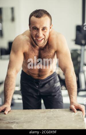 Portrait einer jungen körperlich fit Mann in Grau Langarm Shirt, seine ...