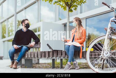 Studenten auf dem Universitätscampus halten soziale Distanz durch Coronavirus Stockfoto