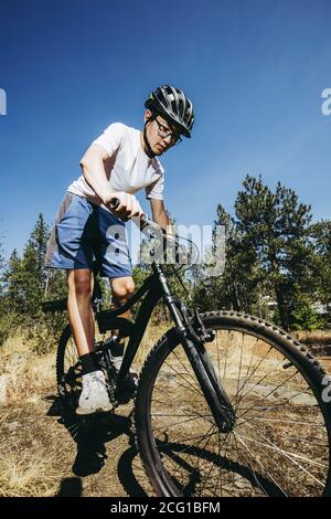 Ein Teenager fährt mit dem Mountainbike auf einem Trail in Nord-Idaho. Stockfoto