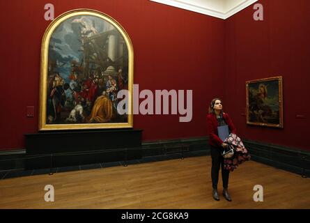 Ein Besucher sieht sich Werke von Paolo Veronese an, während er vor seiner Verehrung der Könige (links) und der Auferstehung Jesu Christi (rechts) steht, während einer Pressevorstellung für die Ausstellung Veronese: Magnificence in Renaissance Venice in der National Gallery, London. Stockfoto