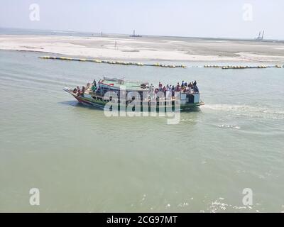 MAWA, BANGLADESCH - 09. MÄRZ 2020: Passagiere überqueren den Padma-Fluss mit der Fähre in Mawa, Bangladesch. Fährschiffe sind in Bangladesch und oft überlastet Stockfoto