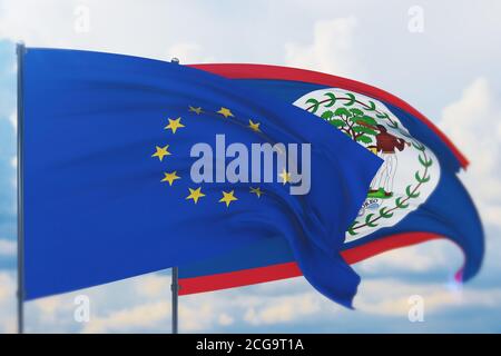 Flagge der Europäischen Union und Flagge von Belize schwenken. Nahaufnahme, 3D-Illustration. Stockfoto