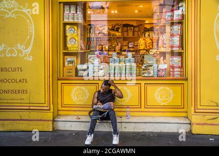 Eine Pause am Schaufenster des La Cure Gourmande Bisquits Schokoladenshops auf La Canebière in der Altstadt von Marseille, Bouches-du-Rhône d Stockfoto