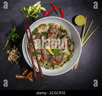Draufsicht Zusammensetzung der Pho bo Suppe. Asiatische Speisen in Schüsseln Stockfoto