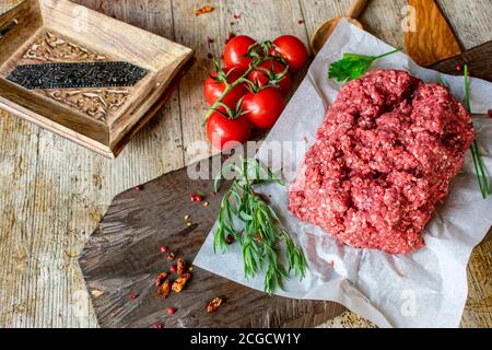 Frisches und rohes Hackfleisch, Hackfleisch aus einem Metzger auf Holztisch Hintergrund Stockfoto