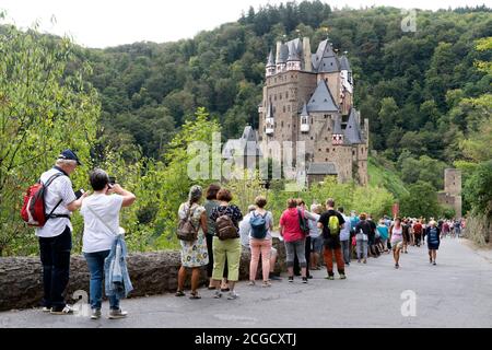 Cochem, Deutschland, 9. September 2020: Urlaub zu Hause: Aufgrund der durch die Corona-Krise verursachten Auslandsreisebeschränkungen verbringen viele Deutsche ihren Urlaub im eigenen Land. Besucher stehen am Eingang zur Burg Eltz in Rheinland-Pfalz, zu der nicht mehr als 200 Personen zugelassen sind und Wartezeiten von mehr als einer Stunde akzeptieren Stockfoto