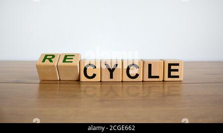Würfel bilden das Wort recyceln auf Holztisch. Schöner weißer Hintergrund. Business- und ökologisches Konzept, Kopierraum. Stockfoto