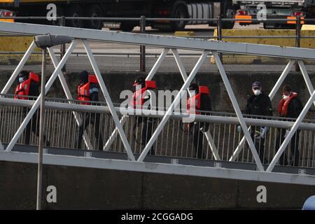 Eine Gruppe von Menschen, die als Migranten gelten, werden nach einem kleinen Bootsunfall im Kanal von Grenzbeamten nach Dover, Kent, gebracht. Stockfoto