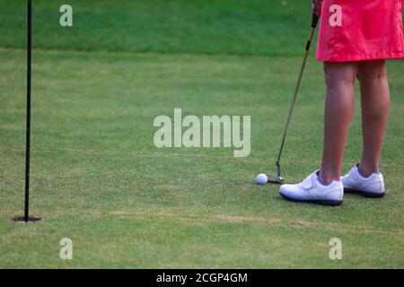 Das Mädchen Golfspieler bereiten für das Schlagen Eisen während des Golftrainings vor Stockfoto