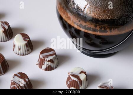 Bombone oder Bisse aus weißer Schokolade, Milchschokolade und dunkler Schokolade, gefüllt mit Haselnusscreme, Erdnussbutter und Dulce de leche. Begleitet von Stockfoto