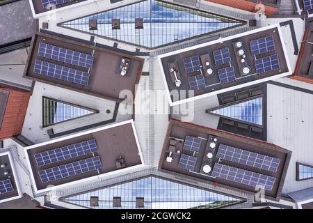 Luftaufnahme der Sonnenkollektoren auf dem Dach eines modernen Gebäudes in Finnland. Stockfoto
