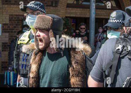 Melbourne, Australien. September 2020. Viktorianische Polizisten führen einen verhafteten Protestierenden auf den Queen Victoria Markets, wo Anti-Maske- und Anti-Lockdown-Demonstranten einen Popup-Protest geplant hatten, Melbourne Australia, fort. Kredit: Michael Currie/Alamy Live Nachrichten Stockfoto