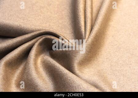 Die Textur aus Kaschmir Stoff beige. Hintergrund, Muster. Stockfoto